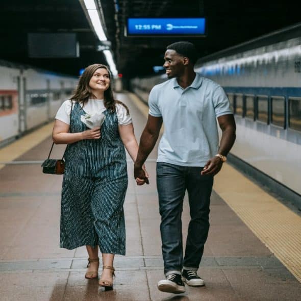 A couple walking together in the city, showing ease and comfort built through mutual trust.