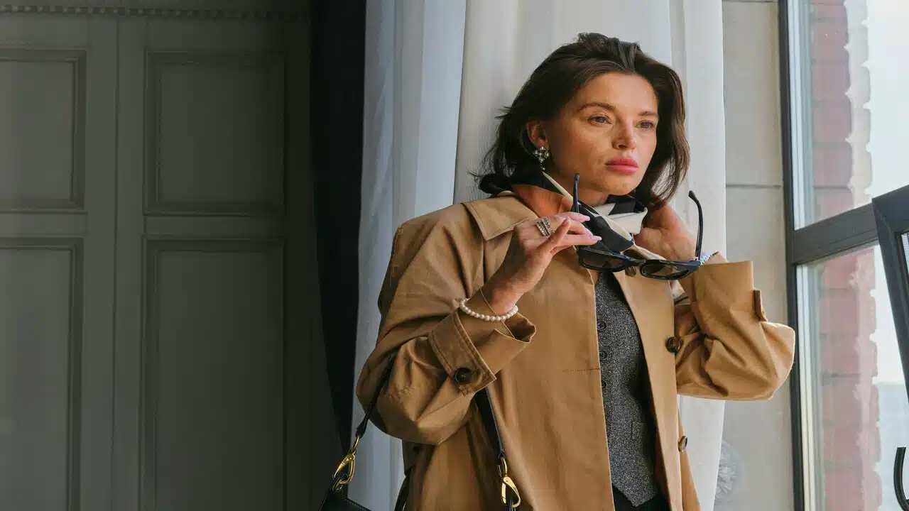 A woman about to put on her glasses.