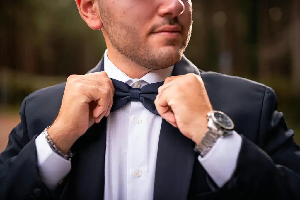 The man is adjusting his bow.