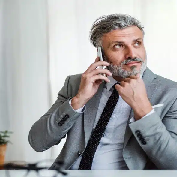 A handsome older man using his phone