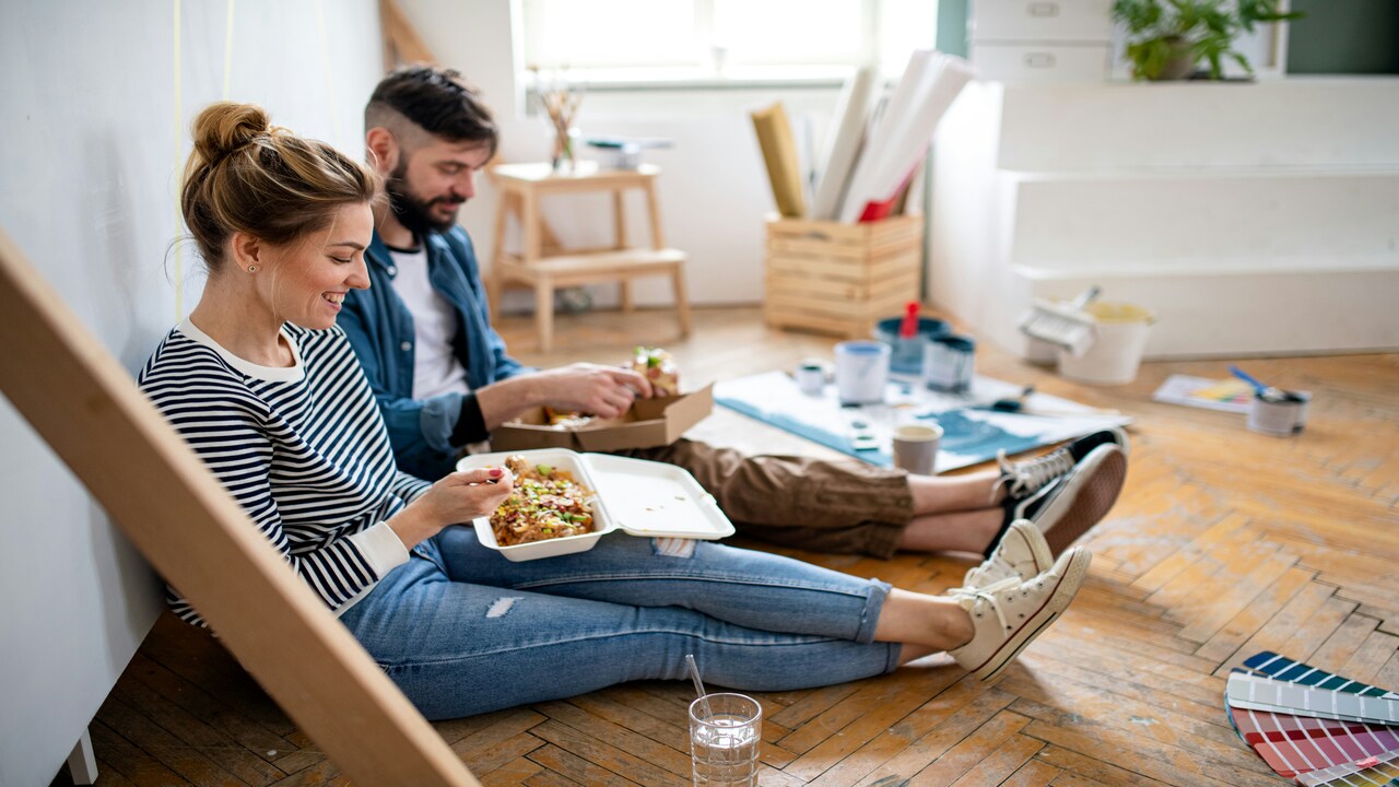 A couple having lunch on the floor