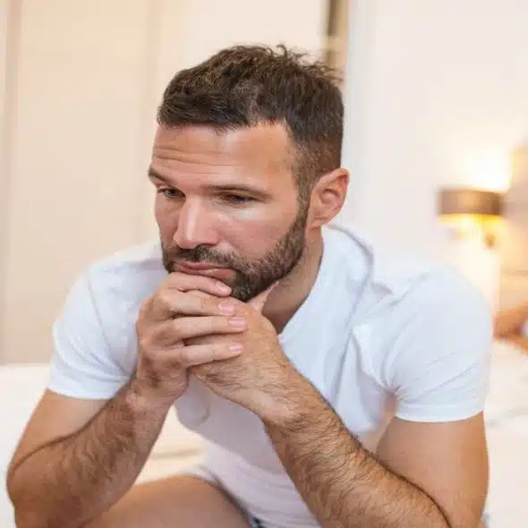 A couple looking sad in bed