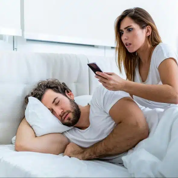 Woman checking man’s phone