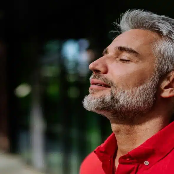 A handsome mature man taking a deep breath
