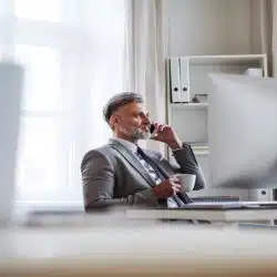 A businessman on the phone and having coffee