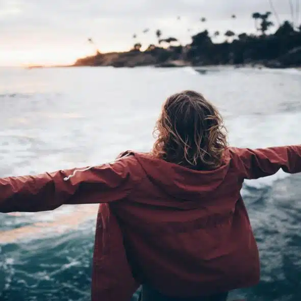 A woman standing near a body of water