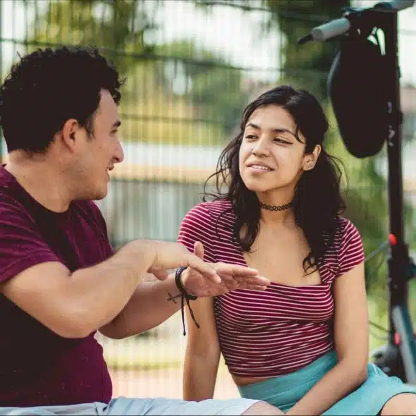 A man saying something to woman