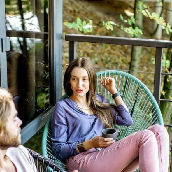 A couple sitting on a balcony