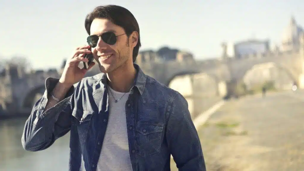 Man in aviator sunglasses under direct sun with confident posture