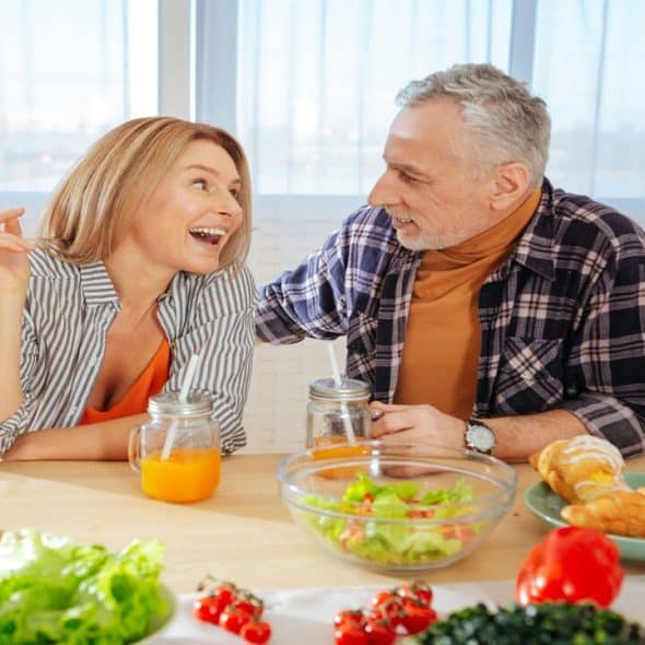 A mature couple having a meal together