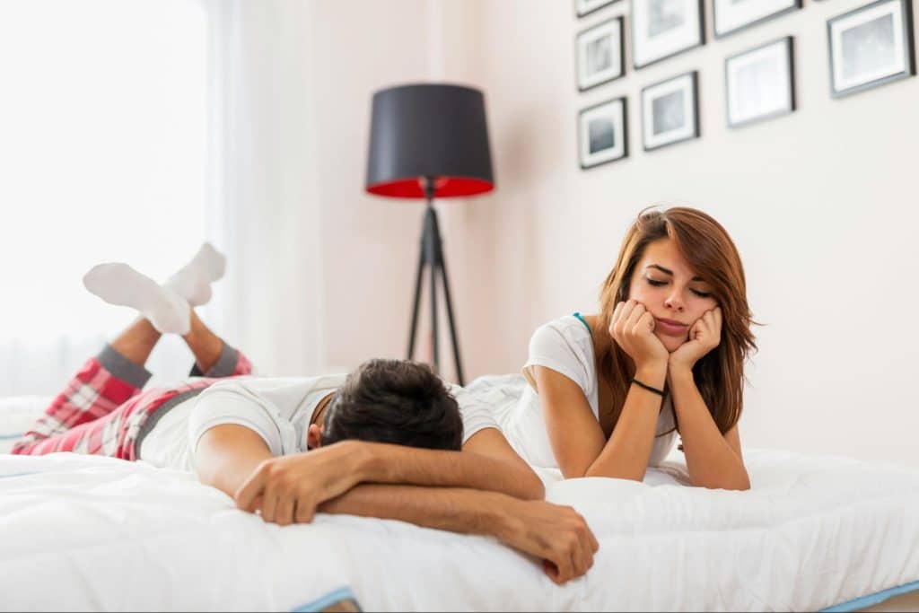 A man and woman at the bed