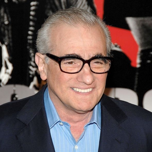 Close-up of Martin Scorsese wearing a black suit and a light blue dress shirt with vertical stripes.