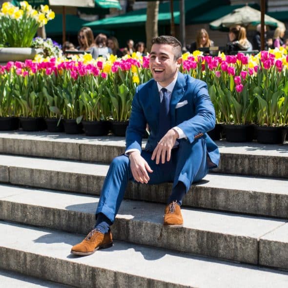 Man Laughing and Sitting on a set of stairs