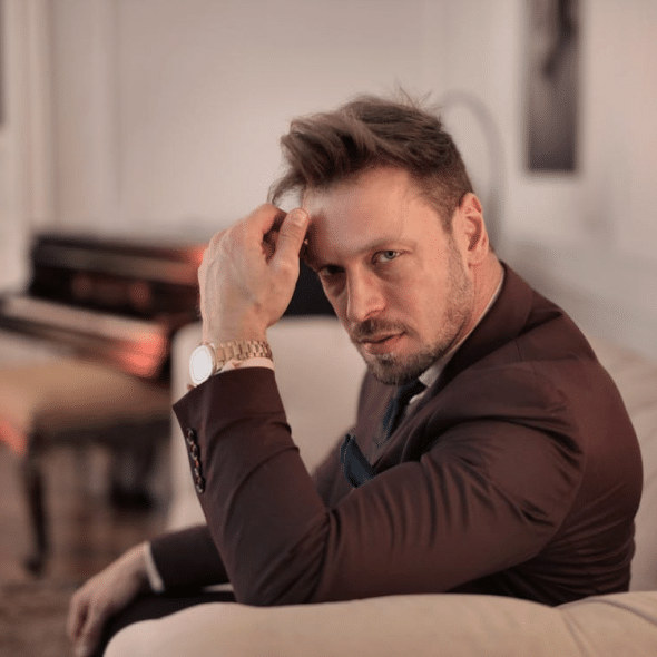 Handsome gentleman resting in luxury living room