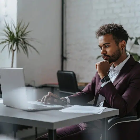 A Man in Maroon Suit Sitting at the Table