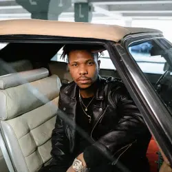 Man in Black Leather Jacket Sitting Inside Car