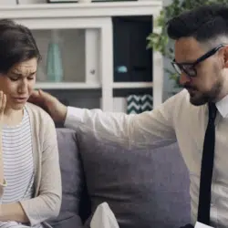 A man comforting his wife