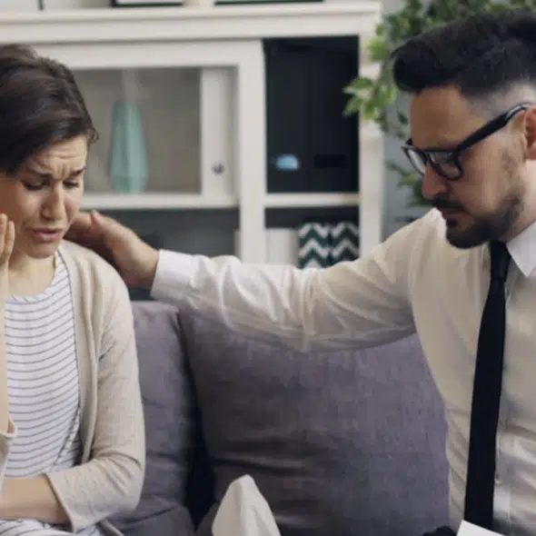 A man comforting his wife