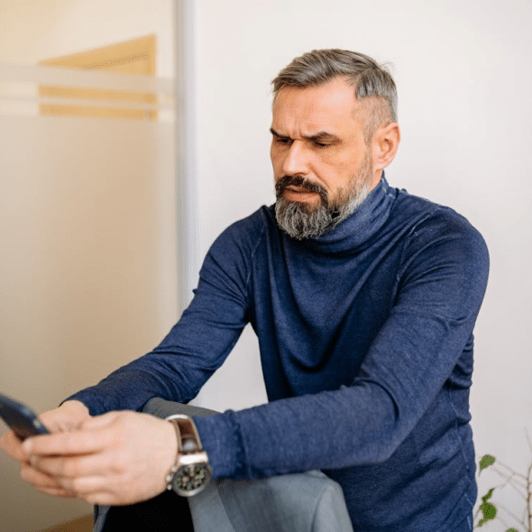 A man scrolling through his phone