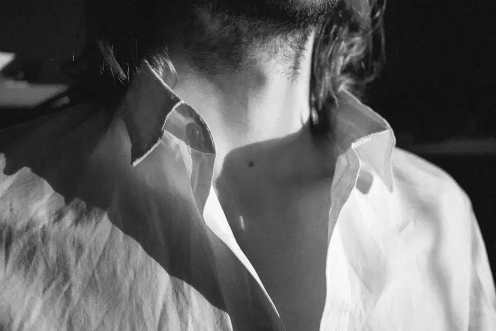 Grayscale Photo of a Man's Neck